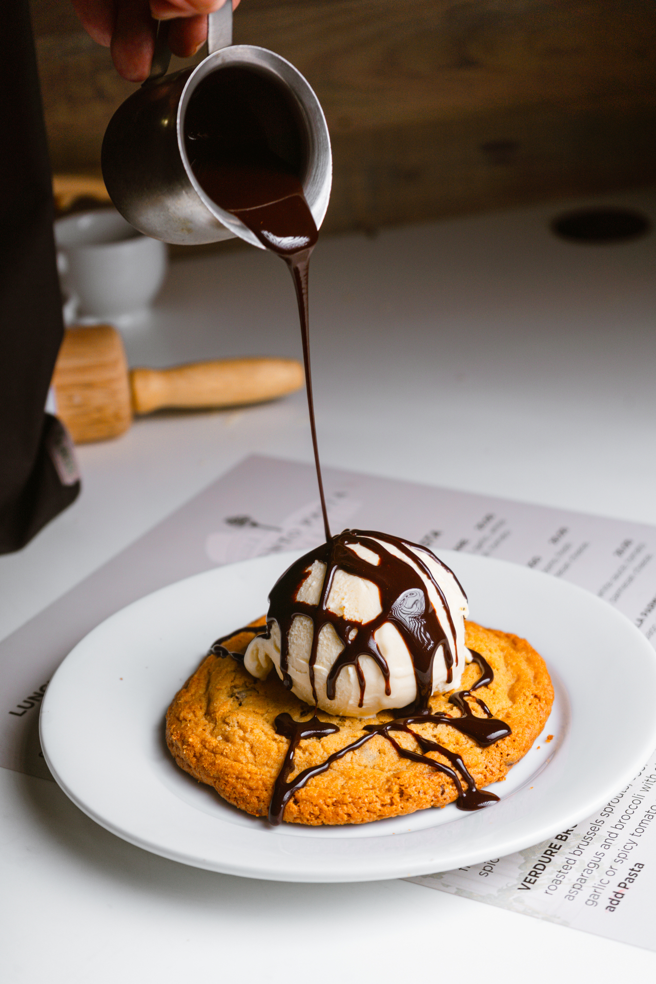 Warm chocolate chip cookie topped with vanilla gelato and hot fudge