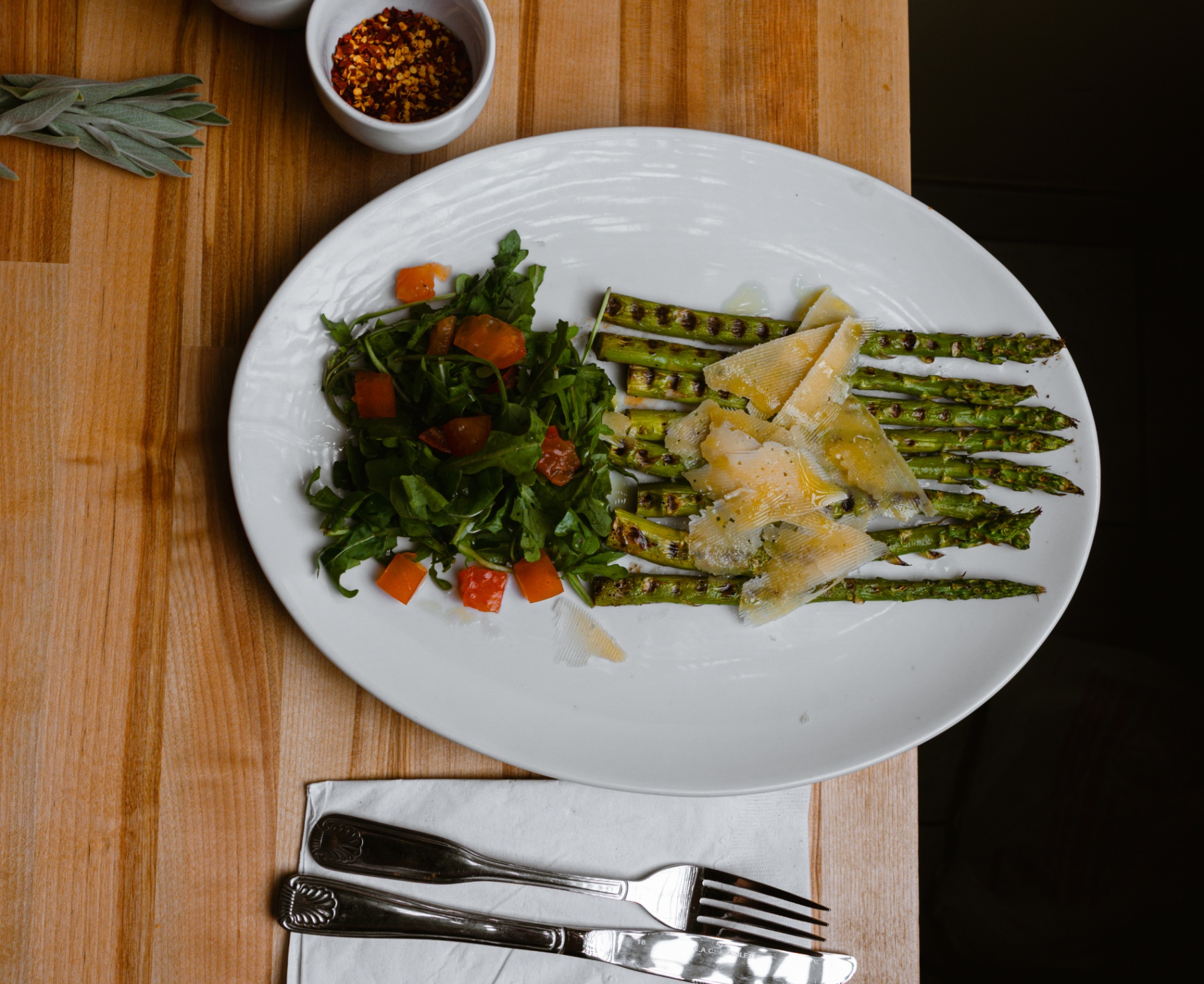 Grilled asparagus with arugula, tomato and shaved parmesan